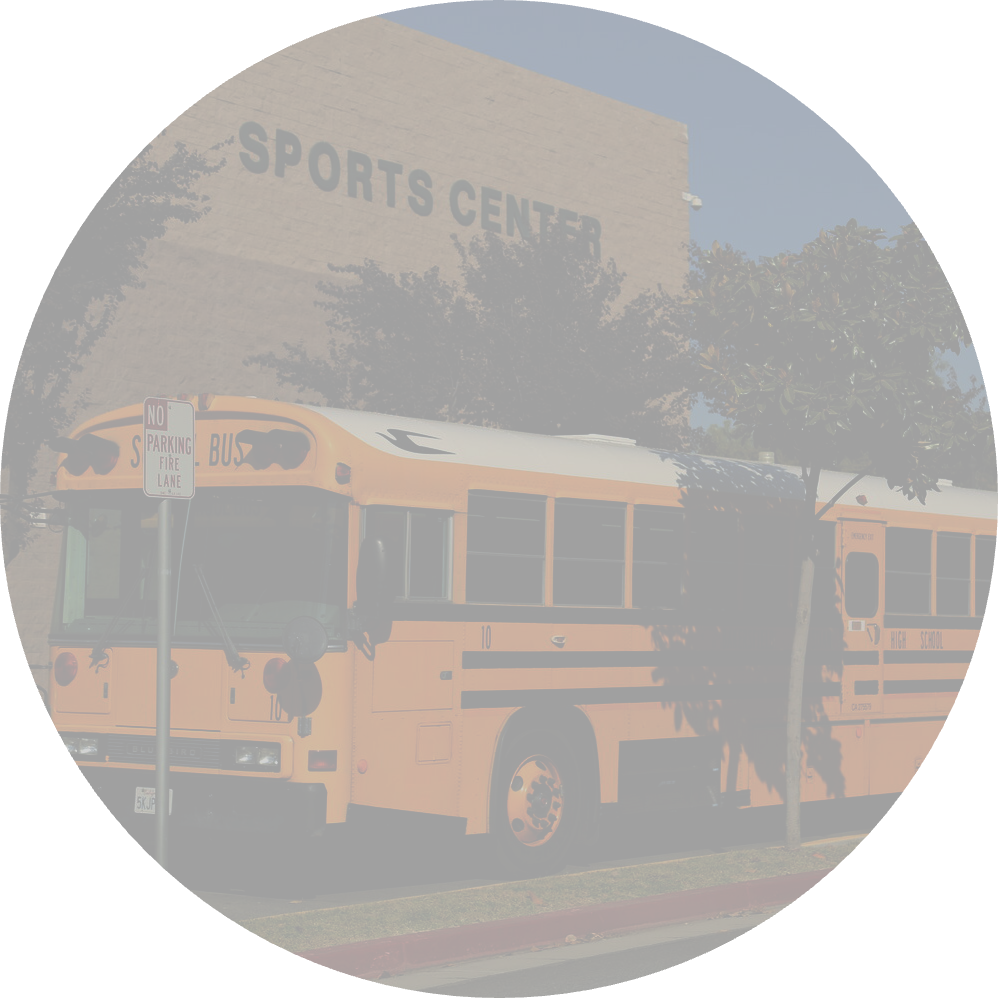 A yellow school bus is parked in front of a building labeled 'Sports Center'.