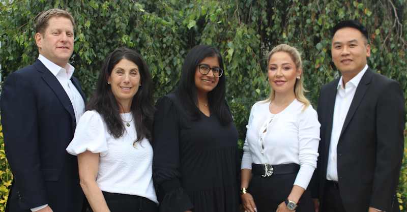 Jericho Board of Education members standing together outdoors - Samuel Perlman (President), Jill Citron (Trustee), Dr. Divya Balachandar (Trustee), Jennifer Vartanov (Vice President), and Kenny Jin (Trustee)